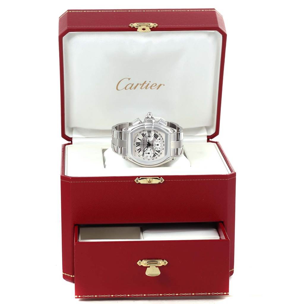 This image shows a Cartier Roadster W62006X6 Men's Stainless Steel Silver Dial W62006X6 Men's Stainless Steel Silver Dial watch in its open, red presentation case with visible branding inside the case lid.