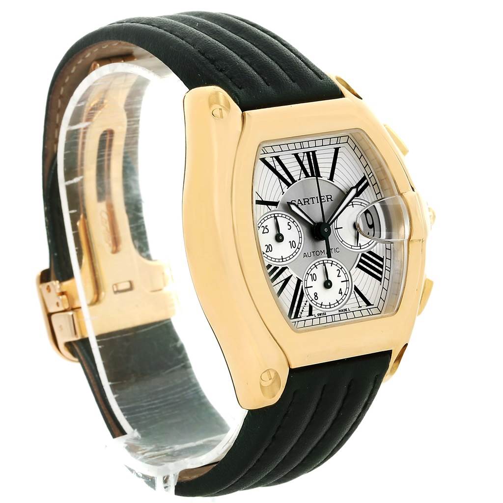The image shows a Cartier Roadster W62021Y2 Men's Yellow Gold Silver Dial W62021Y2 Men's Yellow Gold Silver Dial watch from a side angle, highlighting its face, case, strap, and clasp.