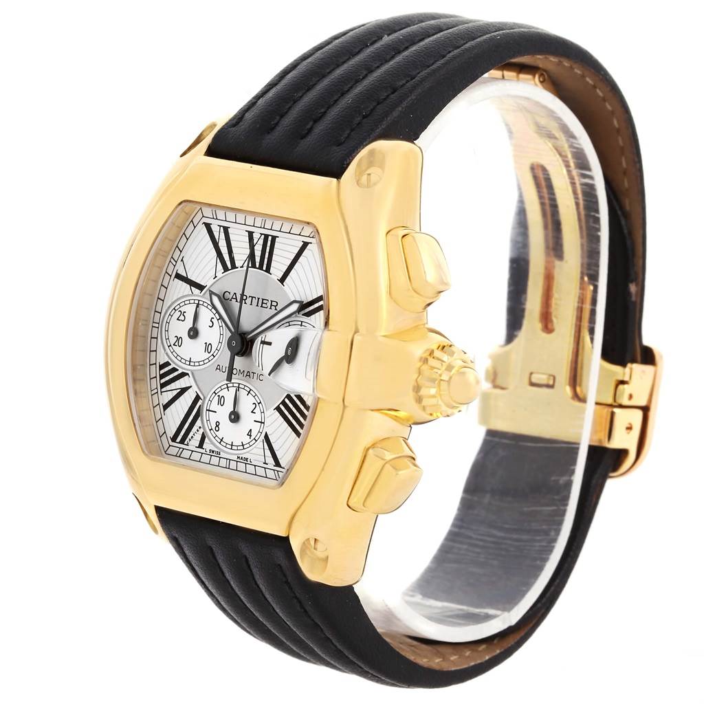 The image shows a Cartier Roadster W62021Y2 Men's Yellow Gold Silver Dial W62021Y2 Men's Yellow Gold Silver Dial watch at an angled side view, highlighting its dial, crown, case, and a black leather strap.