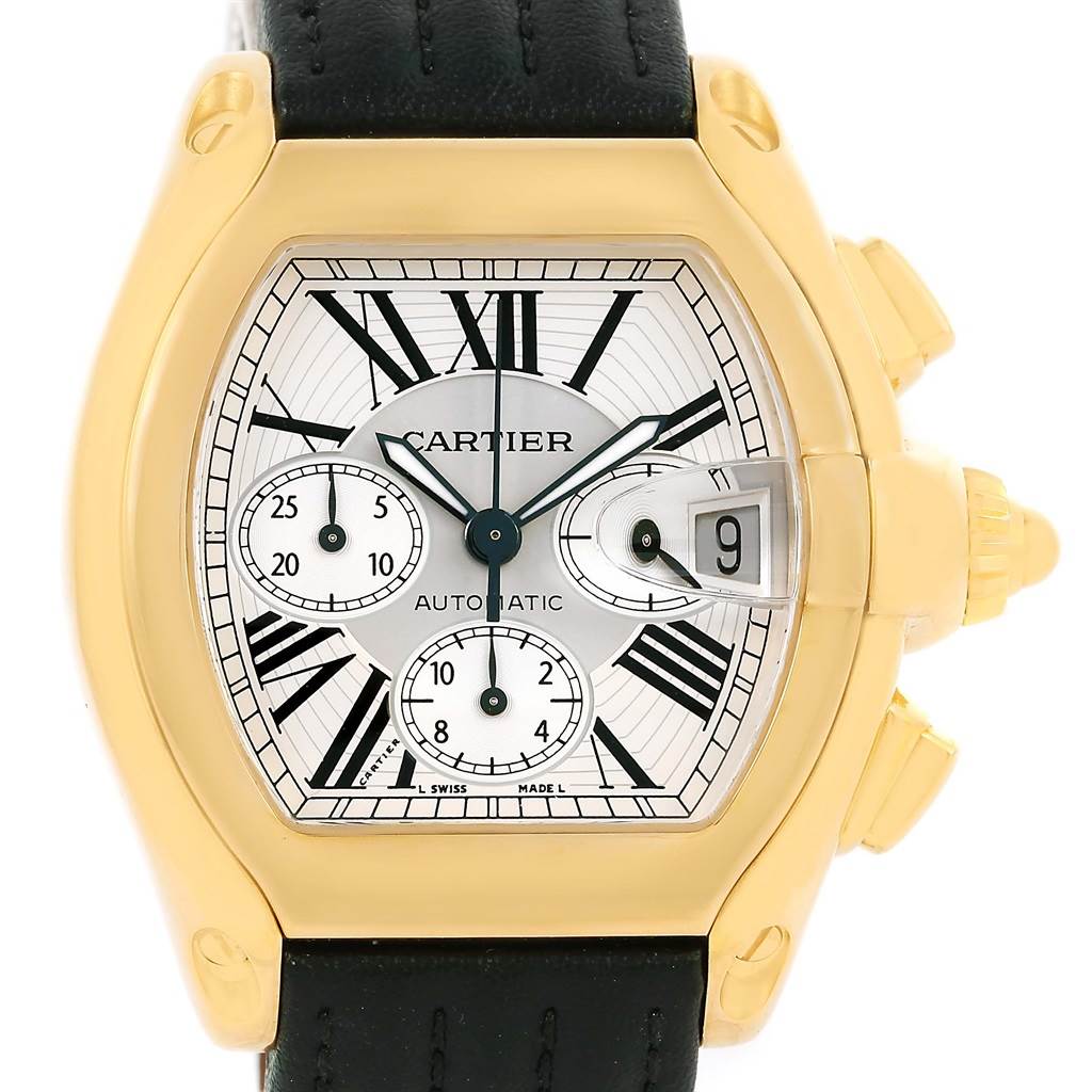 This image shows a Cartier Roadster W62021Y2 Men's Yellow Gold Silver Dial W62021Y2 Men's Yellow Gold Silver Dial watch from a front angle, highlighting its face, gold bezel, dials, and black leather strap.