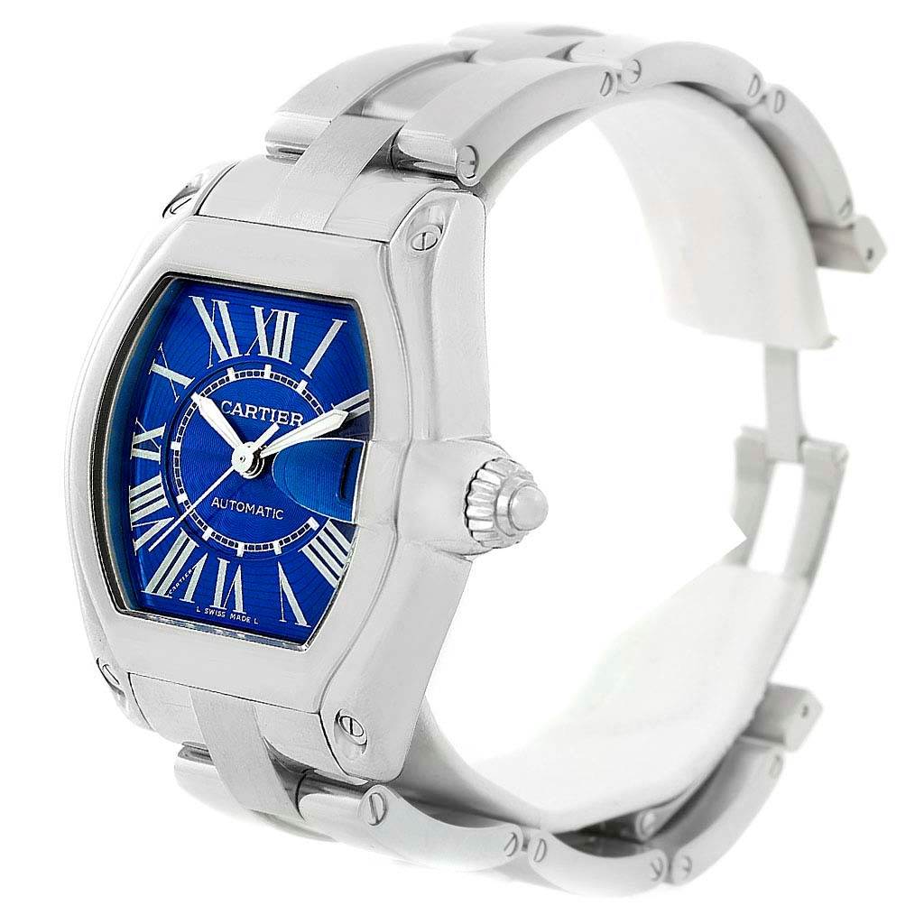The Cartier Roadster W62048V3 Men
s Stainless Steel Blue Dial W62048V3 Men
s Stainless Steel Blue Dial watch is shown at a slightly angled side view, displaying the watch face, crown, and part of the bracelet.