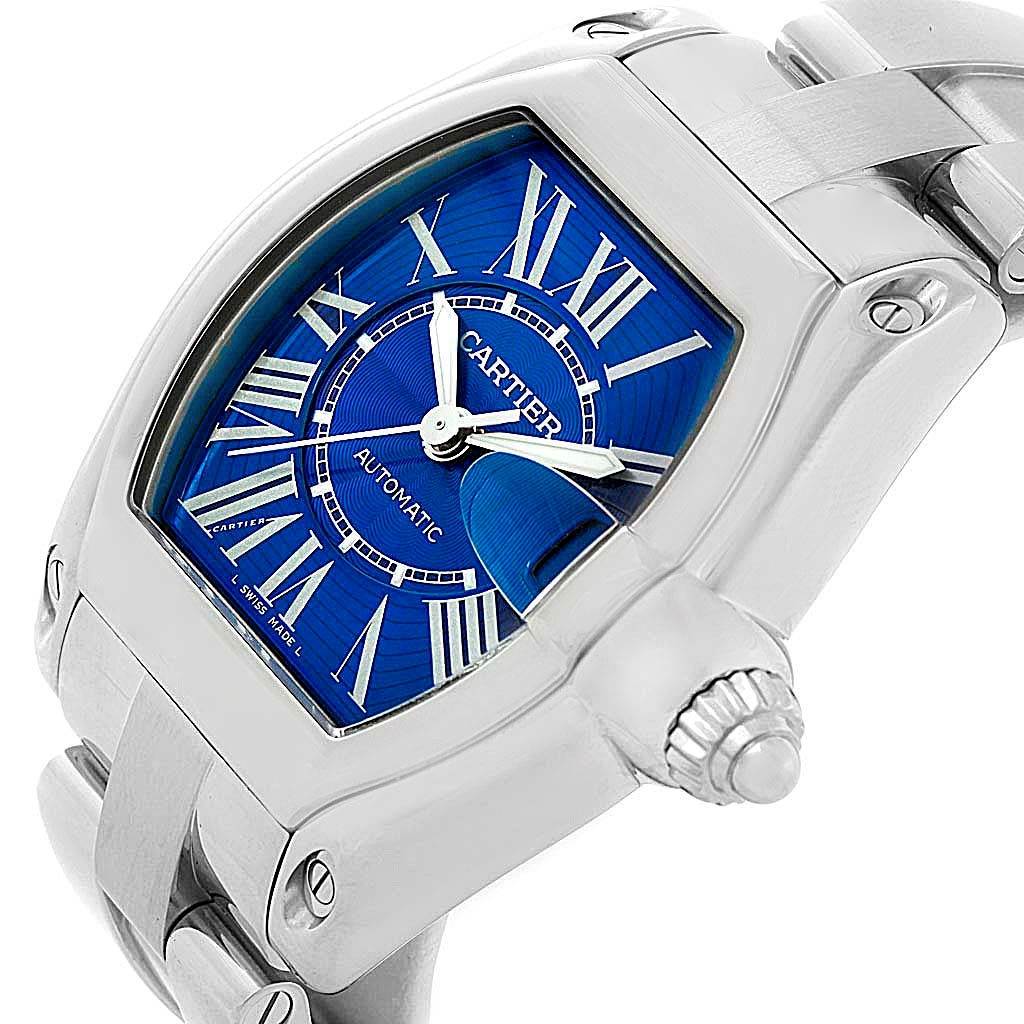 This image shows a Cartier Roadster W62048V3 Men
s Stainless Steel Blue Dial W62048V3 Men
s Stainless Steel Blue Dial watch angled slightly from the side, highlighting its blue dial and stainless steel case and bracelet.