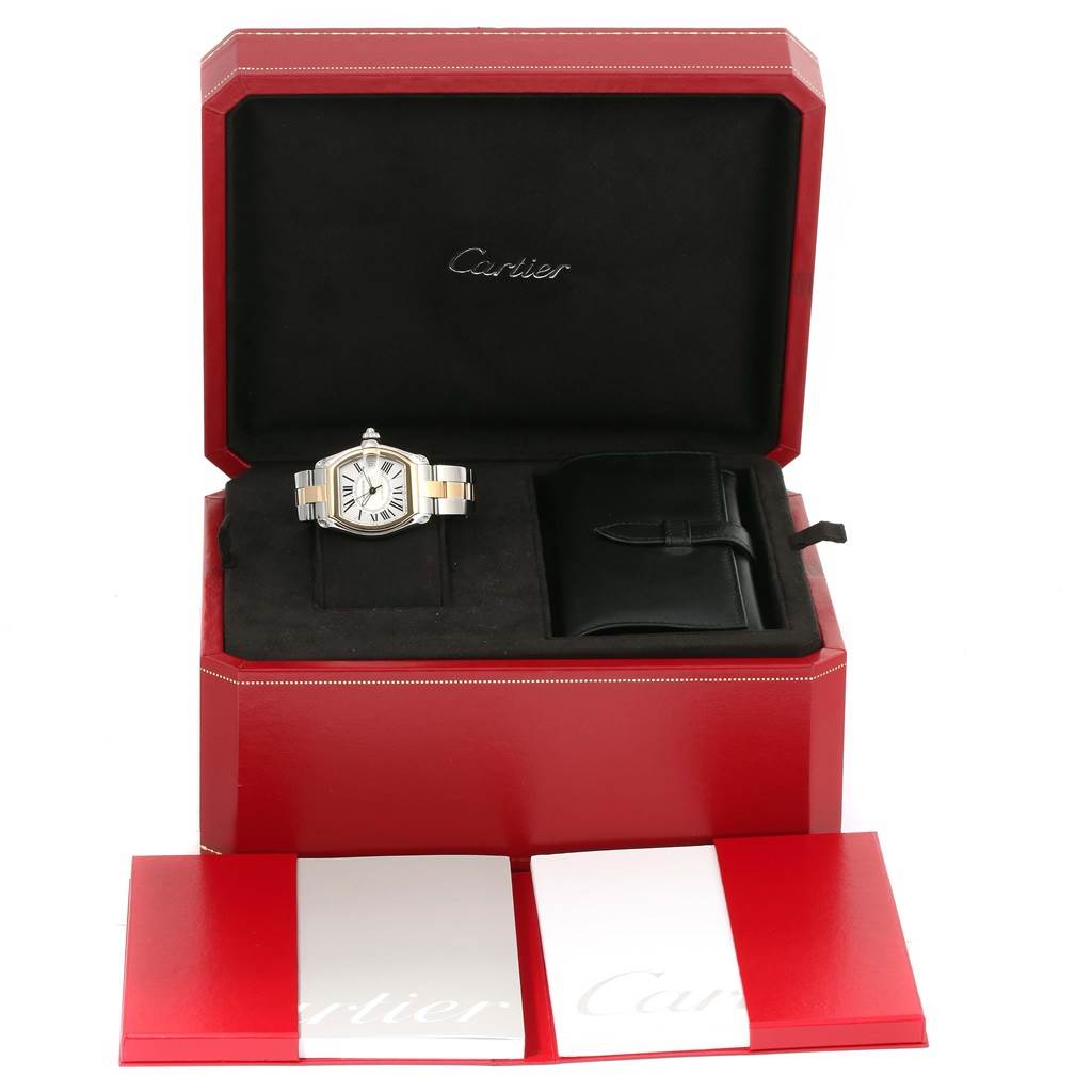 The angle shows the Cartier Roadster W62031Y4 Men's Steel and Gold (two tone) Silver Dial W62031Y4 Men's Steel and Gold (two tone) Silver Dial watch inside its open box with accessories, including a leather pouch and documents.