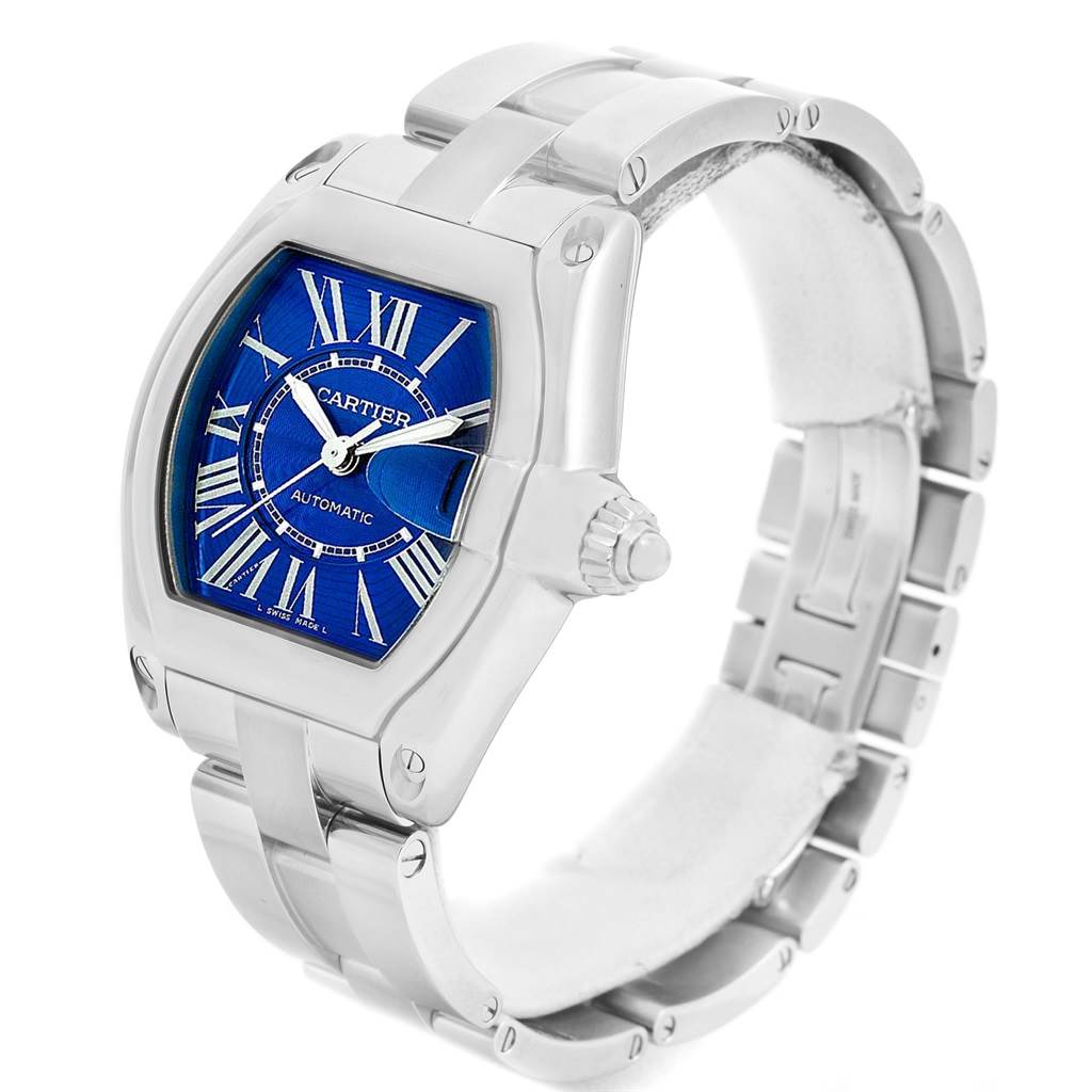 The image shows a Cartier Roadster W62048V3 Men
s Blue Dial W62048V3 Men
s Blue Dial watch at an angle highlighting the face, strap, and crown.