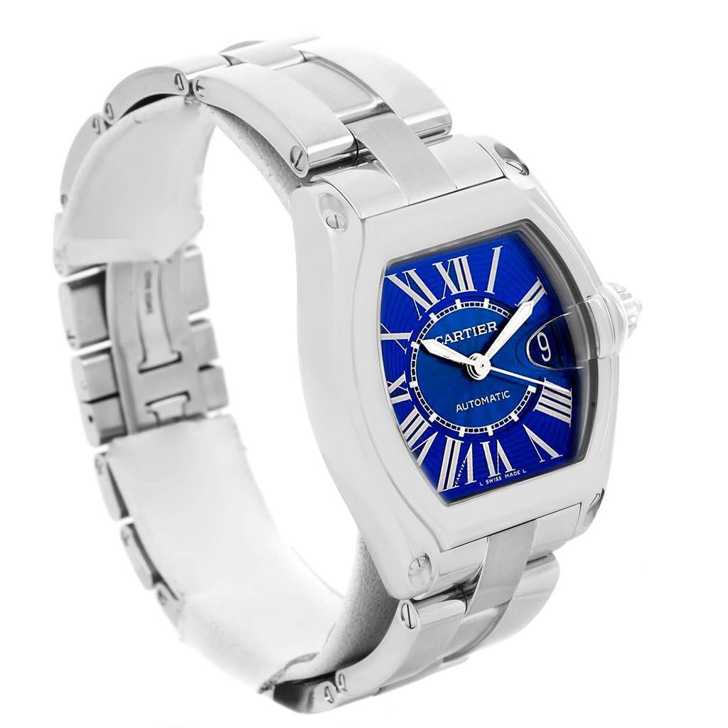 The image shows a Cartier Roadster W62048V3 Men
s Blue Dial W62048V3 Men
s Blue Dial watch from a front diagonal angle, highlighting its stainless steel bracelet, blue dial, and roman numerals.