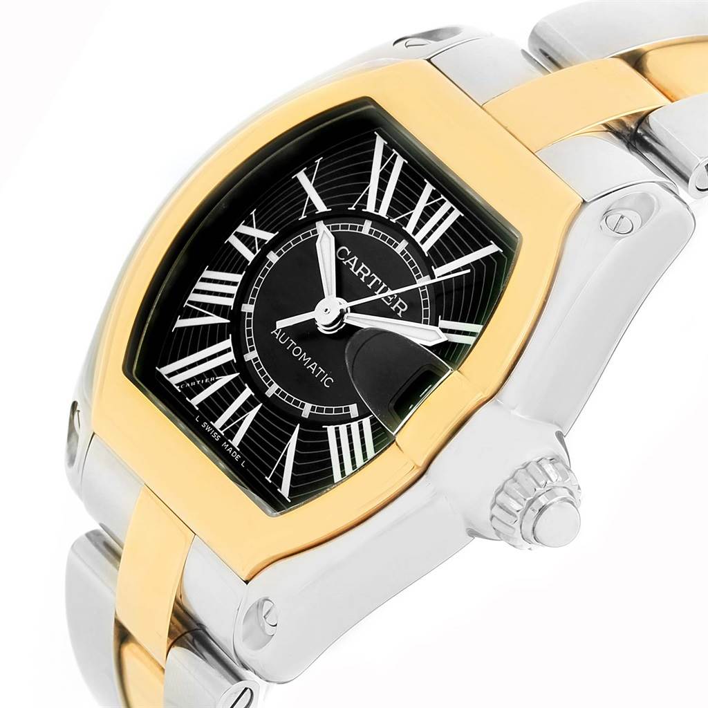 This image shows a close-up of the Cartier Roadster W62031Y4 Men's Steel and Gold (two tone) Black Dial W62031Y4 Men's Steel and Gold (two tone) Black Dial watch's face, crown, and part of its bracelet, viewed at an angle.