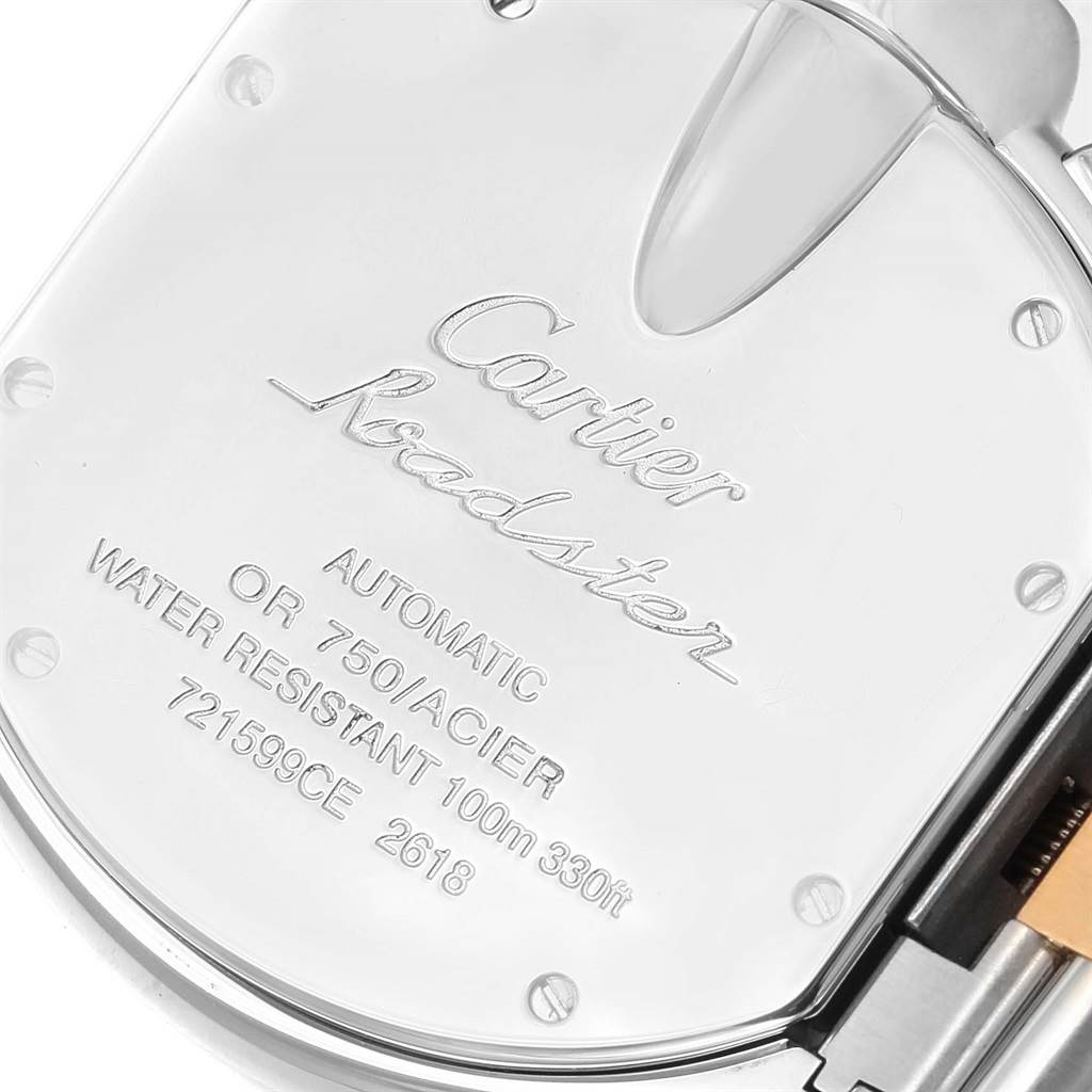 This image shows the back cover of a Cartier Roadster W62027Z1 Men's Steel and Gold (two tone) Silver Dial W62027Z1 Men's Steel and Gold (two tone) Silver Dial watch, highlighting its engravings and some screws.