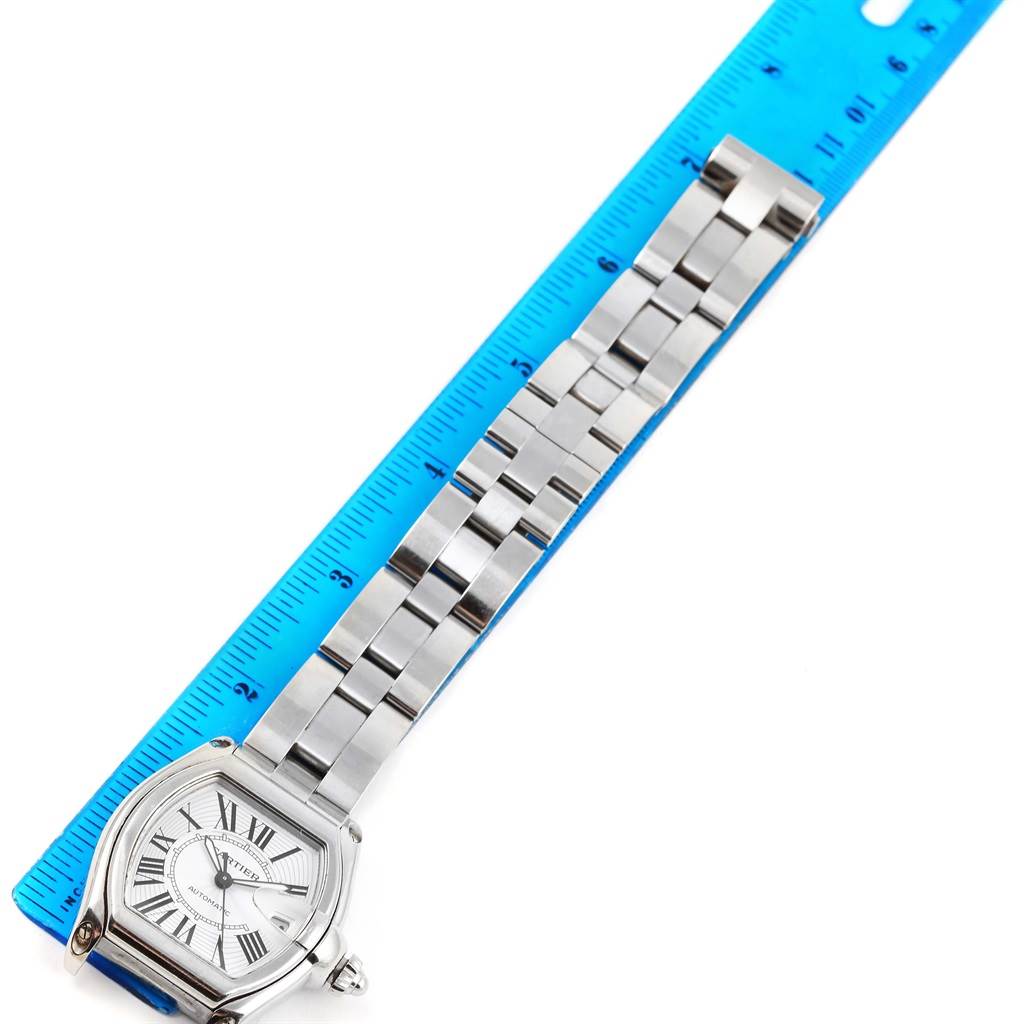 The image shows the face and bracelet of the Cartier Roadster W62025V3 Men
s Stainless Steel Silver Dial W62025V3 Men
s Stainless Steel Silver Dial watch placed next to a blue ruler for size reference.