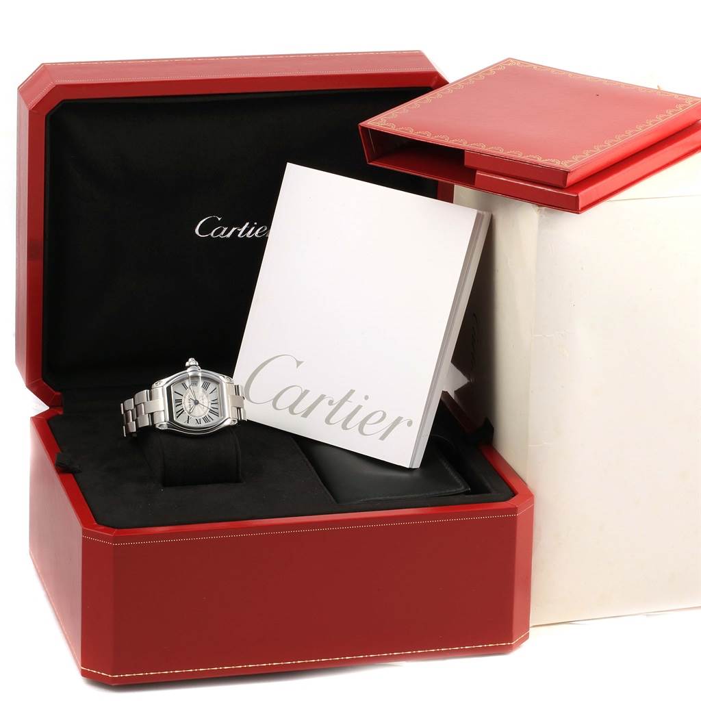 The Cartier Roadster W62025V3 Men
s Stainless Steel Silver Dial W62025V3 Men
s Stainless Steel Silver Dial watch is shown in its opened box, accompanied by a booklet and red outer packaging.