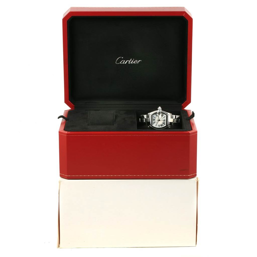 The Cartier Roadster W62025V3 Men's Stainless Steel Silver Dial W62025V3 Men's Stainless Steel Silver Dial watch is displayed inside its red box, showing its face and metal band from a front angle.