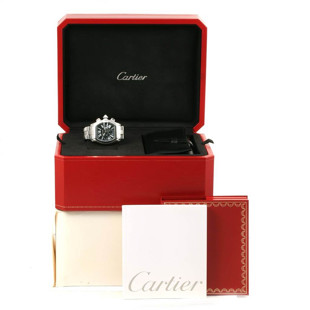 The Cartier Roadster W62020X6 Men
s Stainless Steel Black Dial W62020X6 Men
s Stainless Steel Black Dial watch is displayed head-on inside its red box, with accompanying accessories and documents.