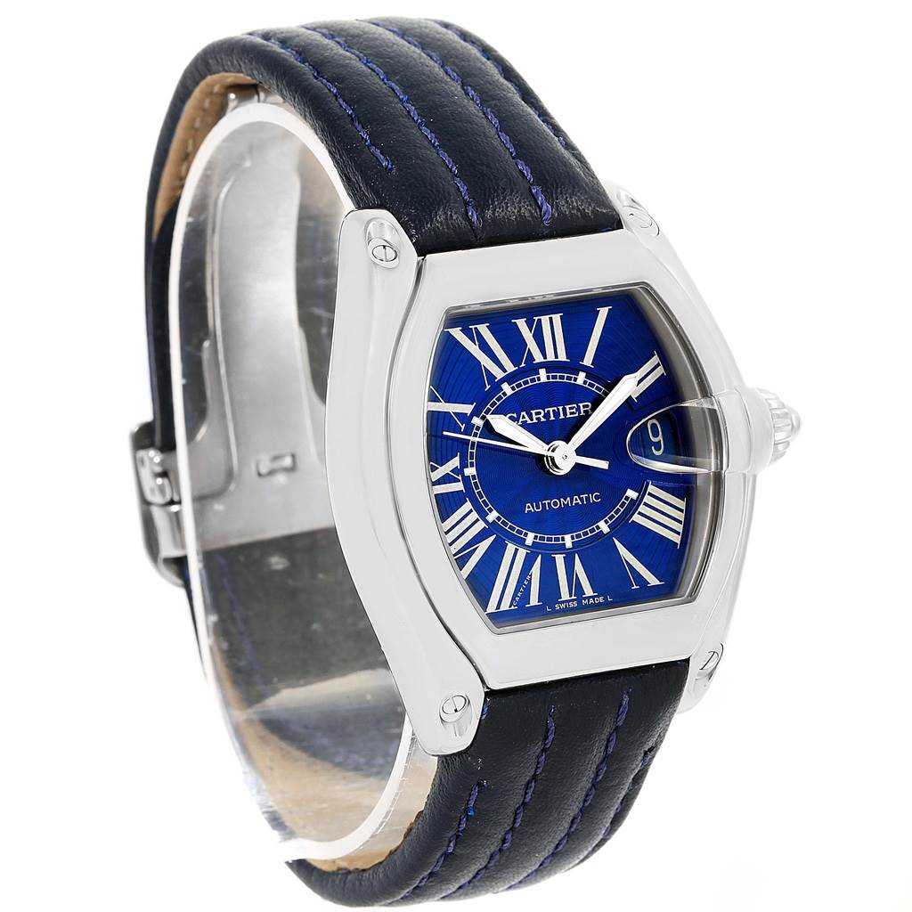 This is a Cartier Roadster W62048V3 Men's Stainless Steel Blue Dial W62048V3 Men's Stainless Steel Blue Dial watch with a blue dial, black leather strap, and a silver-toned case, shown from an angled side view.