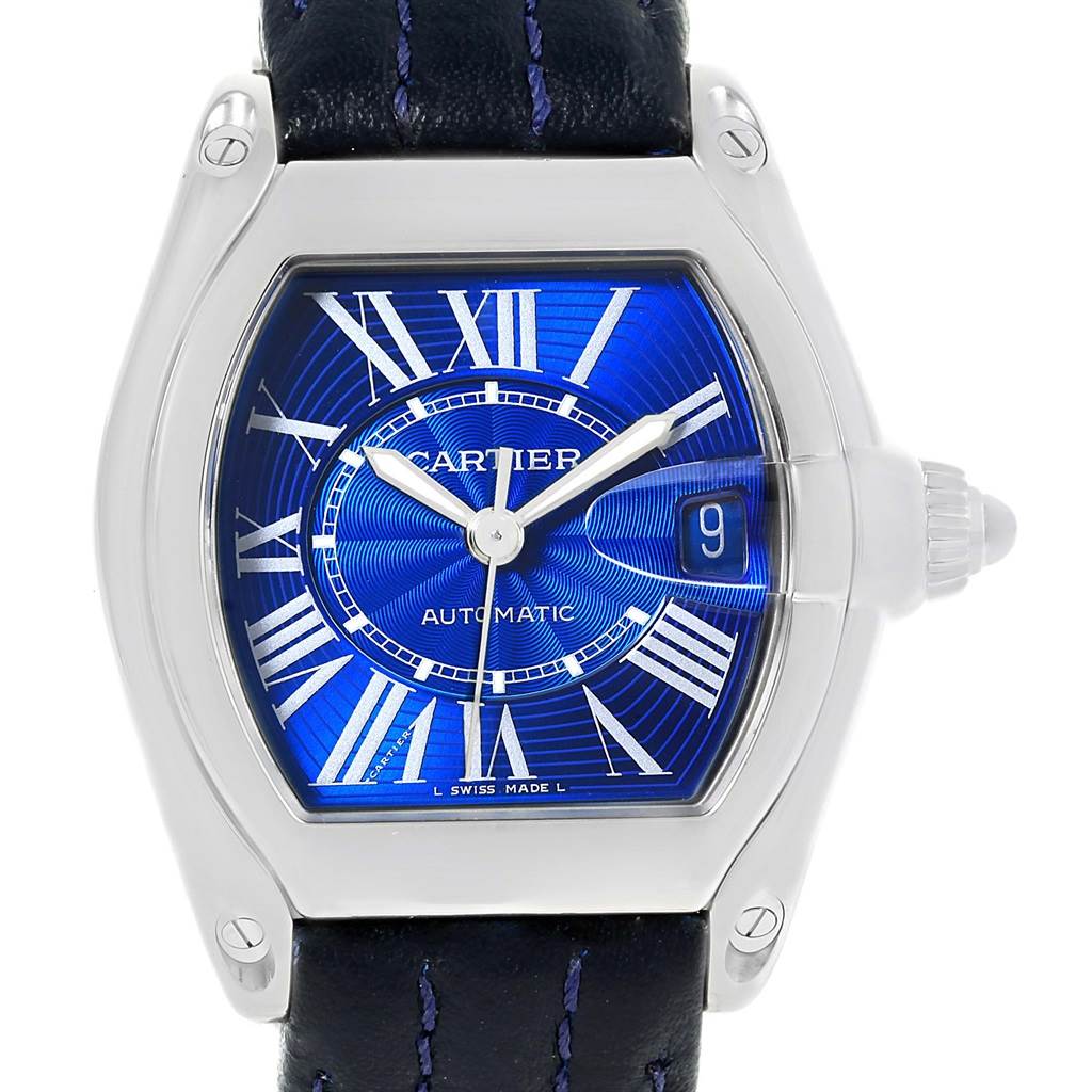 The Cartier Roadster W62048V3 Men's Stainless Steel Blue Dial W62048V3 Men's Stainless Steel Blue Dial watch is shown from a front angle, displaying its blue dial, Roman numerals, and black leather strap.