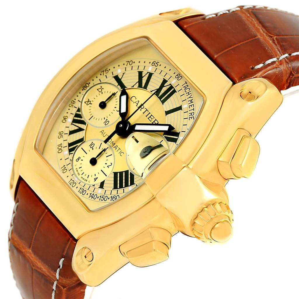 This image shows a close-up, side-angle view of the Cartier Roadster W62021Y3 Men
s Yellow Gold Champagne Dial W62021Y3 Men
s Yellow Gold Champagne Dial watch, highlighting its dial, crown, and brown leather strap.