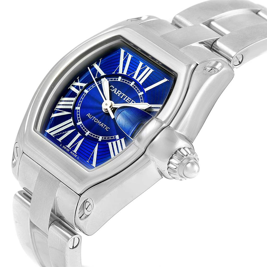 The image shows a close-up of the Cartier Roadster W62048V3 Men's Stainless Steel Blue Dial W62048V3 Men's Stainless Steel Blue Dial watch, displaying the face, bezel, crown, and bracelet.