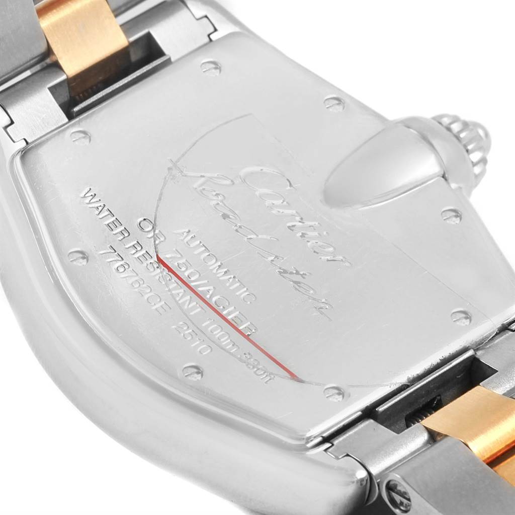The image shows the back case and bracelet of a Cartier Roadster W62031Y4 Men's Steel and Gold (two tone) Silver Dial W62031Y4 Men's Steel and Gold (two tone) Silver Dial watch, focusing on the clasp and engraving details.
