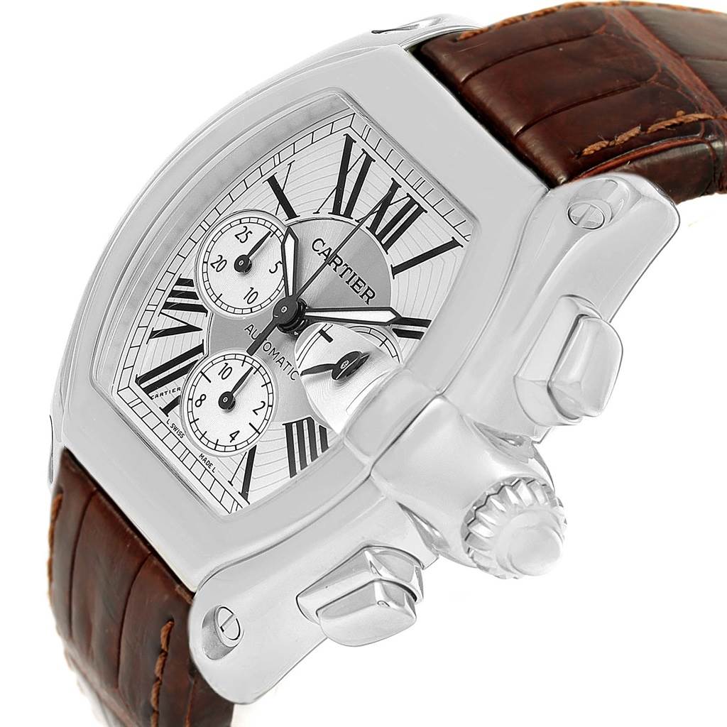The Cartier Roadster W62019X6 Men's Stainless Steel Silver Dial W62019X6 Men's Stainless Steel Silver Dial watch is shown from a diagonal angle, highlighting the dial, crown, pushers, and brown leather strap.