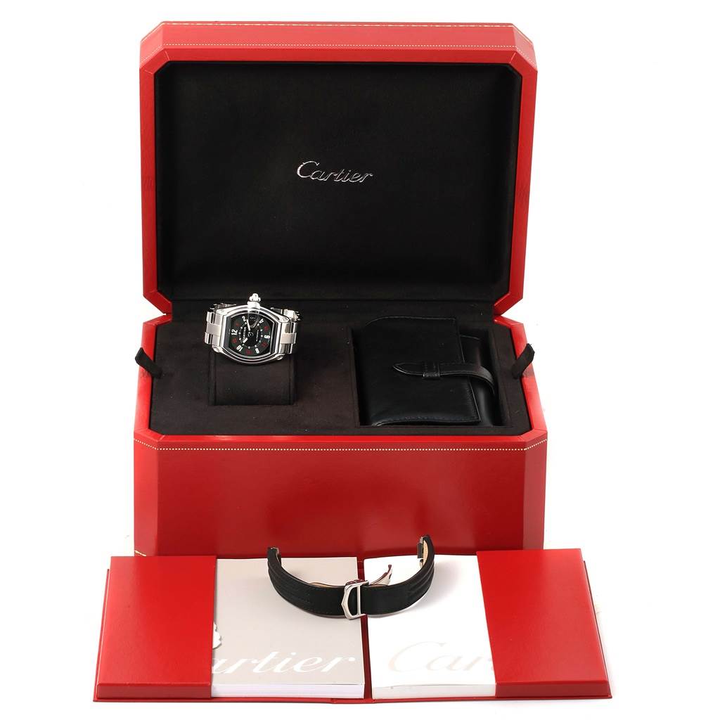The image shows a Cartier Roadster W62002V3 Men's Stainless Steel Black Dial W62002V3 Men's Stainless Steel Black Dial watch, extra strap, and booklets inside an open Cartier case.
