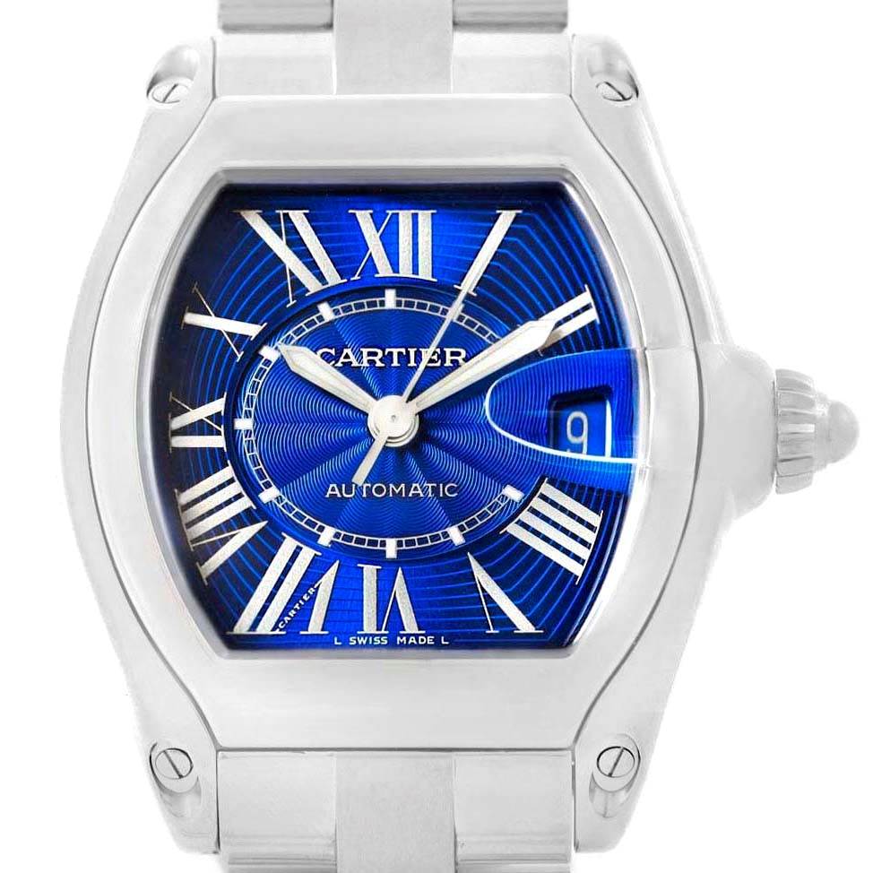 The image shows a frontal view of the Cartier Roadster W62048V3 Men's Stainless Steel Blue Dial W62048V3 Men's Stainless Steel Blue Dial watch, highlighting its blue dial, Roman numerals, and stainless steel casing and bracelet.