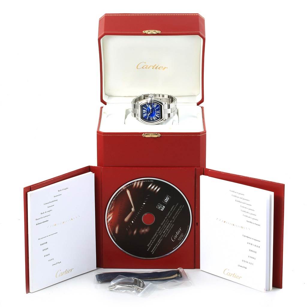 The Cartier Roadster W62048V3 Men's Stainless Steel Blue Dial W62048V3 Men's Stainless Steel Blue Dial watch is displayed in its box with a CD, booklets, and additional accessories shown.