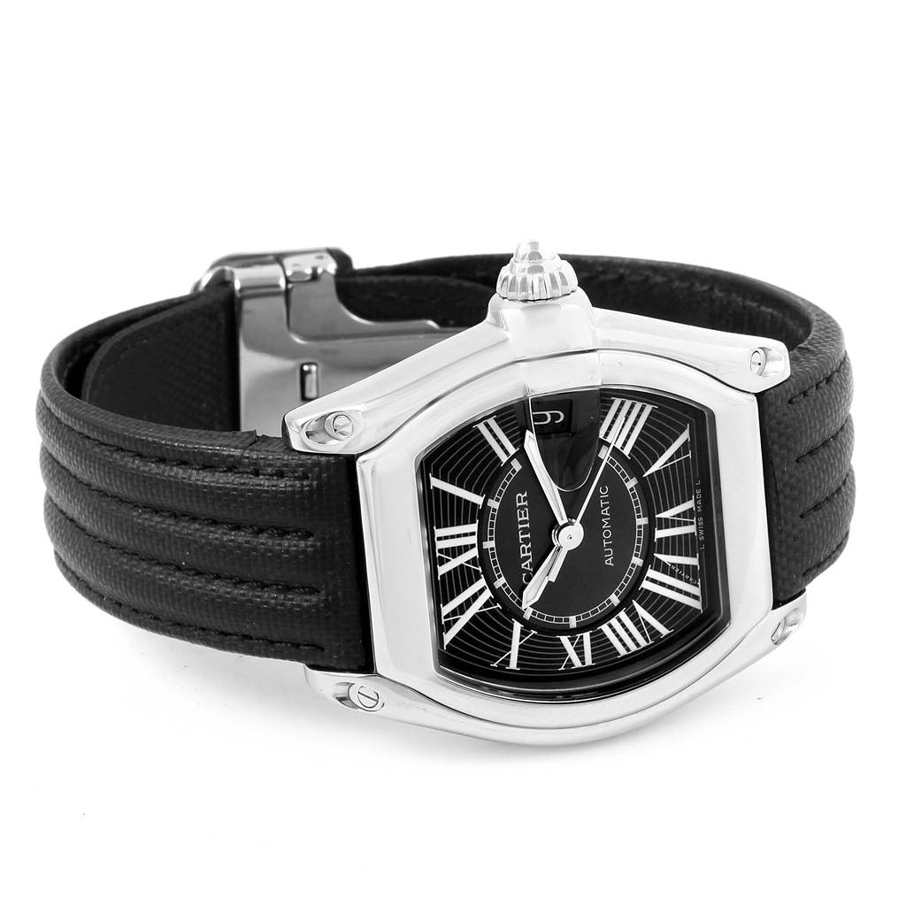 The image shows a Cartier Roadster W62041V3 Men
s Stainless Steel Black Dial W62041V3 Men
s Stainless Steel Black Dial watch at an angle highlighting its black dial, Roman numerals, and black leather strap.