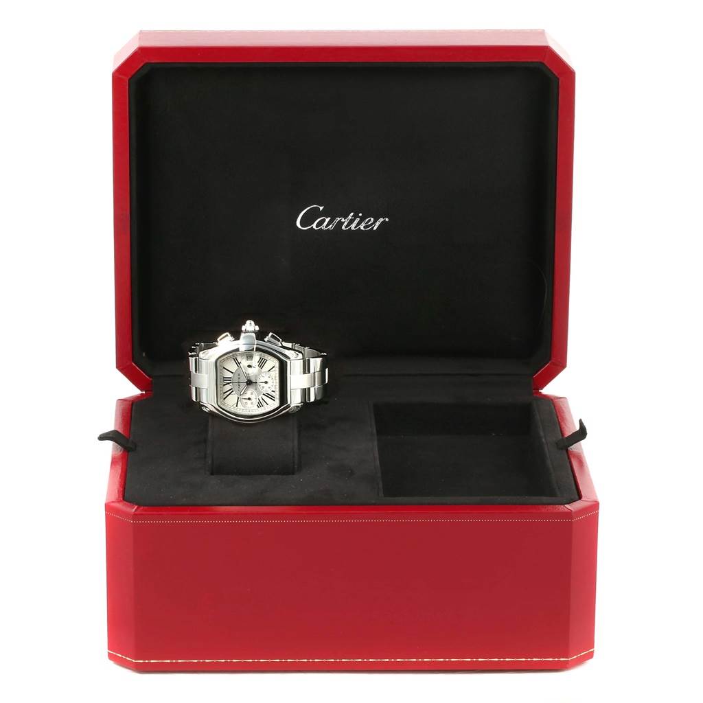 The Cartier Roadster W62019X6 Men's Stainless Steel Silver Dial W62019X6 Men's Stainless Steel Silver Dial watch is displayed inside an open red case, showcasing its face and stainless steel bracelet.