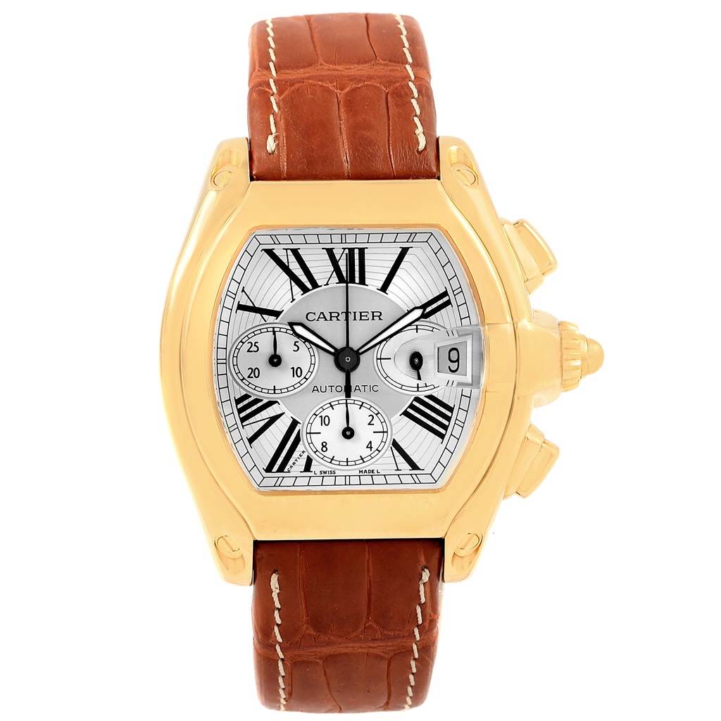 The image shows a Cartier Roadster W62021Y2 Men's Yellow Gold Silver Dial W62021Y2 Men's Yellow Gold Silver Dial watch from a front angle, featuring its dial, brown leather strap, and side buttons.