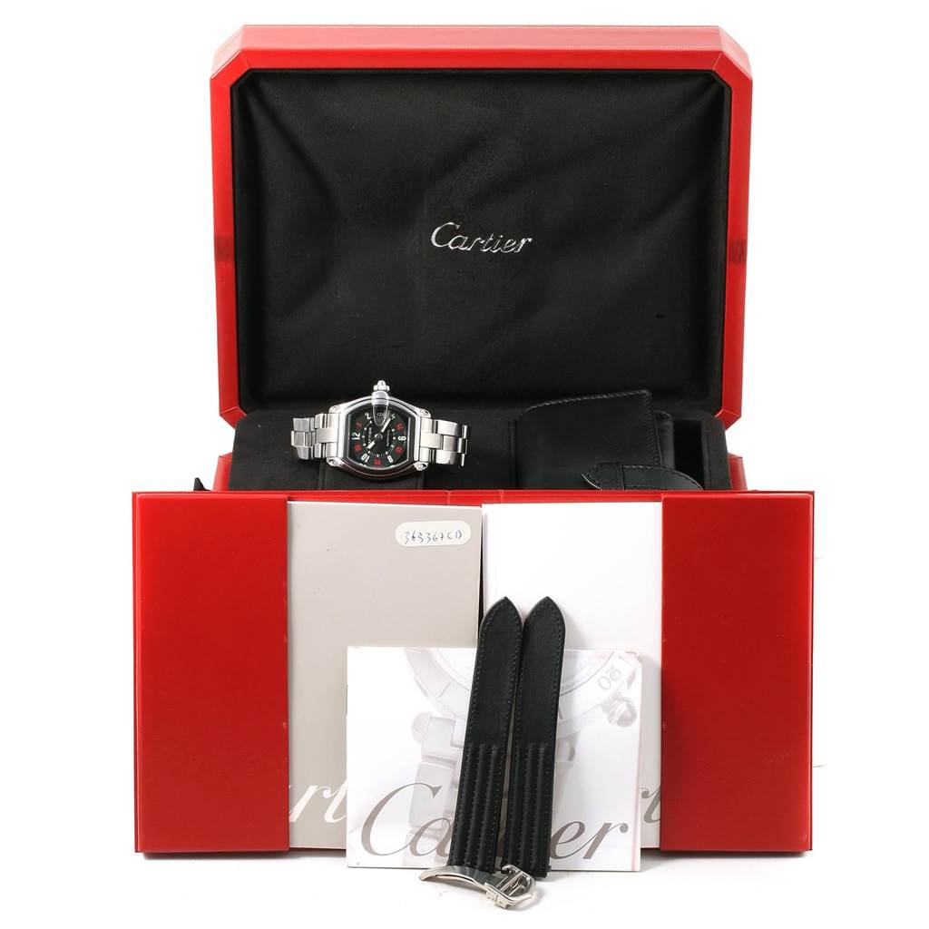 The Cartier Roadster W62002V3 Men's Stainless Steel Black Dial W62002V3 Men's Stainless Steel Black Dial watch is shown from the front in its box with accessories, including booklets, additional straps, and a warranty card.