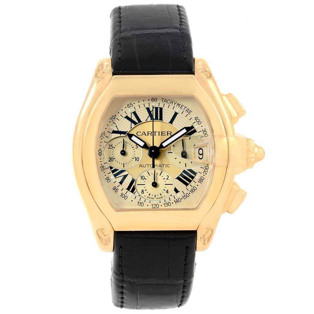 The image shows a Cartier Roadster W62021Y3 Men's Yellow Gold Champagne Dial W62021Y3 Men's Yellow Gold Champagne Dial watch from a front angle, featuring its dial, case, and black leather strap.