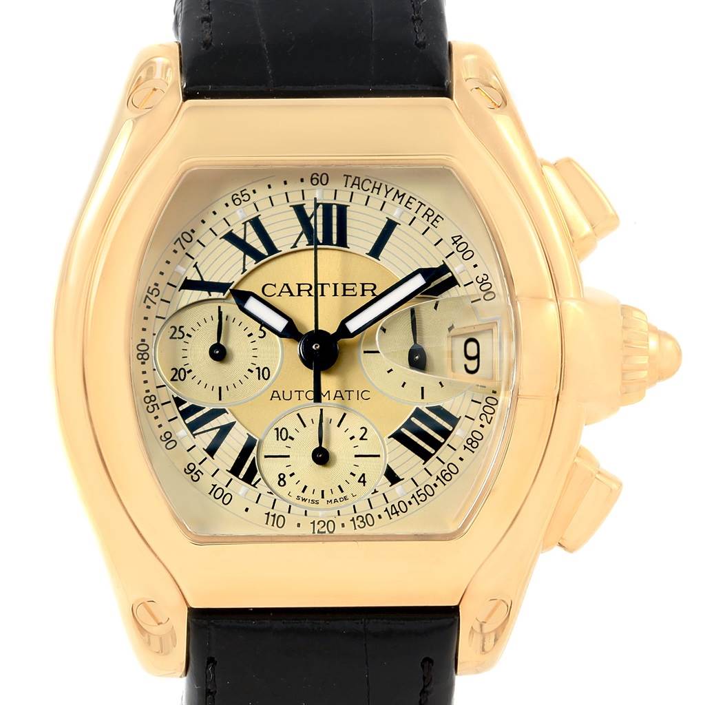 The image shows a Cartier Roadster W62021Y3 Men's Yellow Gold Champagne Dial W62021Y3 Men's Yellow Gold Champagne Dial watch front and center, highlighting its dial, hands, subdials, and black leather strap.