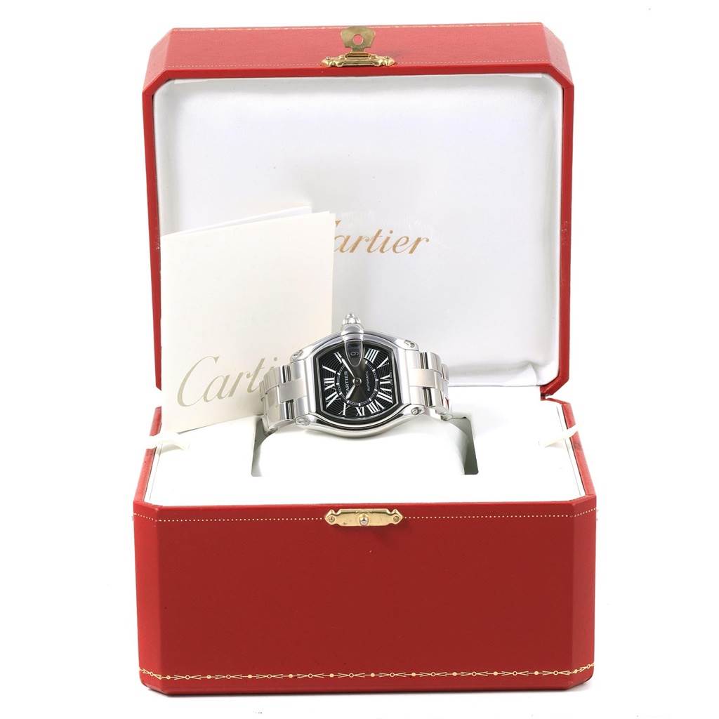 The Cartier Roadster W62041V3 Men
s Stainless Steel Black Dial W62041V3 Men
s Stainless Steel Black Dial watch is shown front-on in an open red box, with visible watch face, bracelet, and accompanying documents.