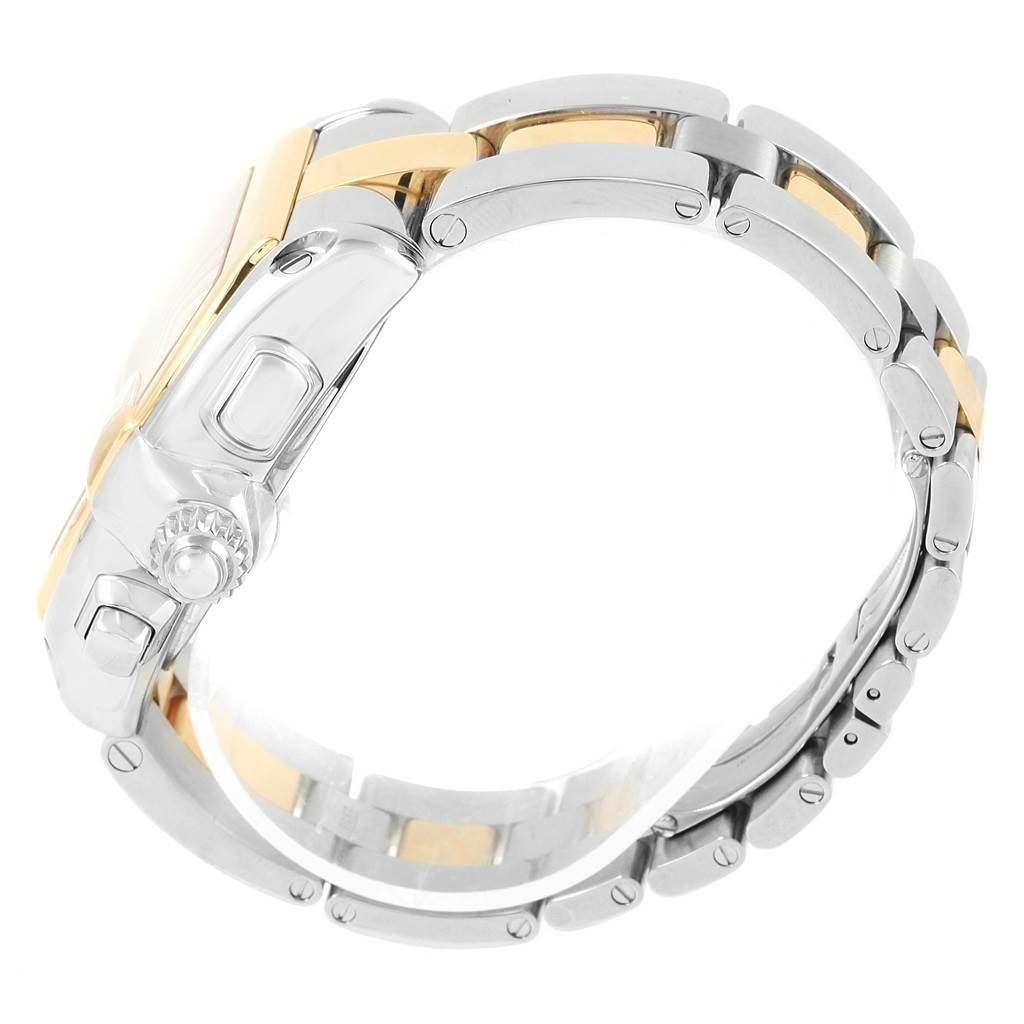 The Cartier Roadster W62027Z1 Men
s Steel and Gold (two tone) Silver Dial W62027Z1 Men
s Steel and Gold (two tone) Silver Dial watch is shown here from a side angle, highlighting the crown, pushers, and two-tone metal bracelet.