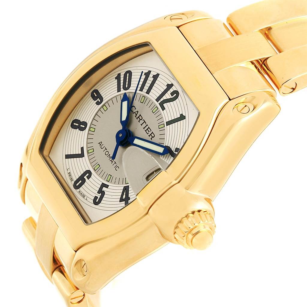 This image shows a close-up side angle of the Cartier Roadster W62005V1 Men's Yellow Gold Silver Dial W62005V1 Men's Yellow Gold Silver Dial watch, highlighting its gold case, dial, and part of the bracelet.