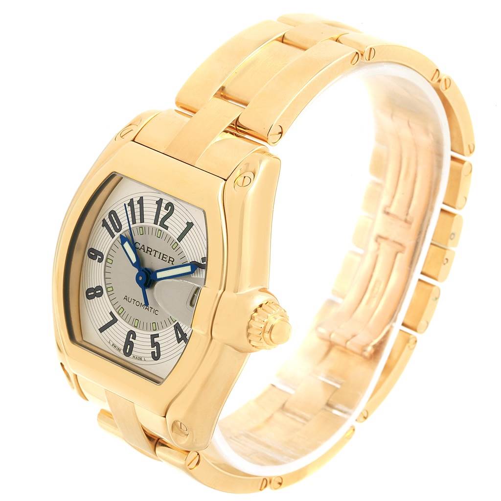 The image shows a Cartier Roadster W62005V1 Men's Yellow Gold Silver Dial W62005V1 Men's Yellow Gold Silver Dial watch from an angled view, highlighting the face, bezel, crown, and part of the bracelet.