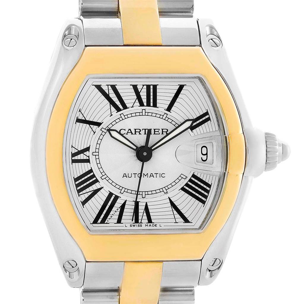 The image shows a Cartier Roadster W62031Y4 Men's Steel and Gold (two tone) Silver Dial W62031Y4 Men's Steel and Gold (two tone) Silver Dial model watch, featuring its face with Roman numerals, date window, and part of the bracelet.