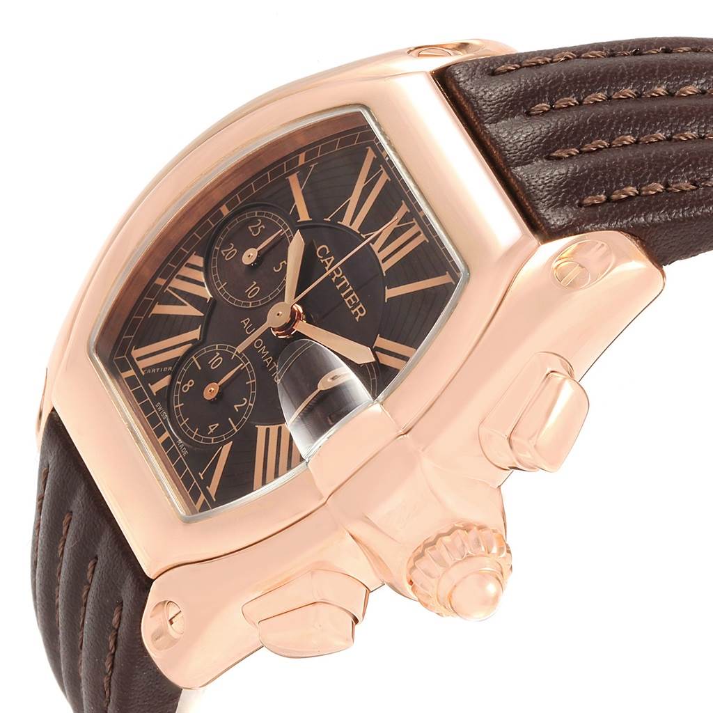 This image shows a close-up side angle of a Cartier Roadster W62042Y5 Men's Rose Gold Brown Dial W62042Y5 Men's Rose Gold Brown Dial watch with its face, crown, and leather strap visible.