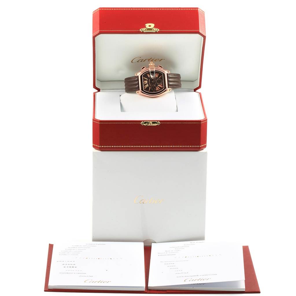 The Cartier Roadster W62042Y5 Men's Rose Gold Brown Dial W62042Y5 Men's Rose Gold Brown Dial watch is presented front-facing in its open red box, with accompanying documents below.