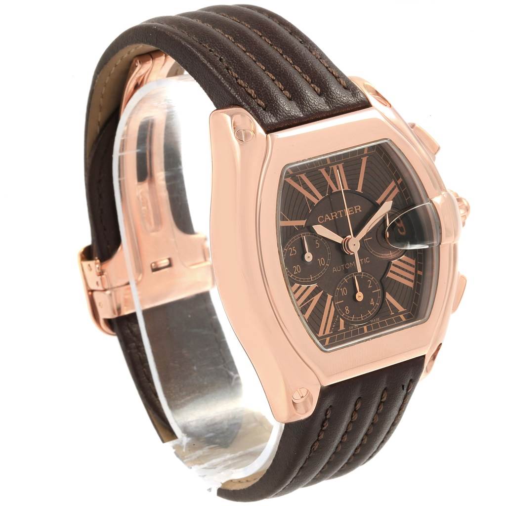 This image shows a Cartier Roadster W62042Y5 Men's Rose Gold Brown Dial W62042Y5 Men's Rose Gold Brown Dial watch at a three-quarter angle, highlighting its rose gold case, leather strap, and dial details.