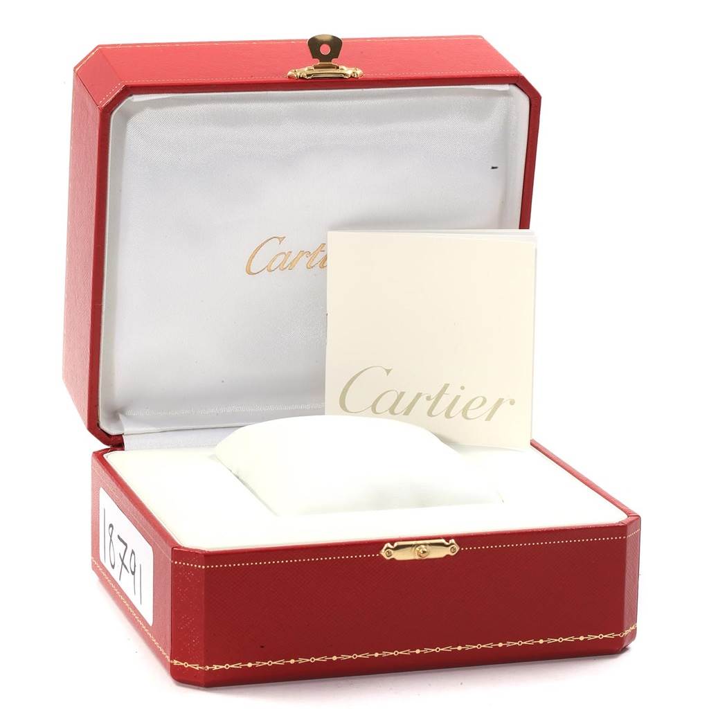 The image shows an empty red Cartier Roadster W6206020 Men
s Stainless Steel Silver Dial W6206020 Men
s Stainless Steel Silver Dial watch box with a pillow and booklet inside.