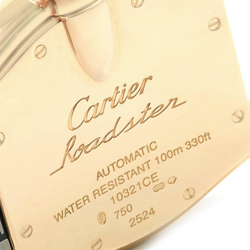 The image shows the back case of a Cartier Roadster W62005V2 Men's Yellow Gold Silver Dial W62005V2 Men's Yellow Gold Silver Dial watch at an angle, featuring engraved details including the model name and specifications.