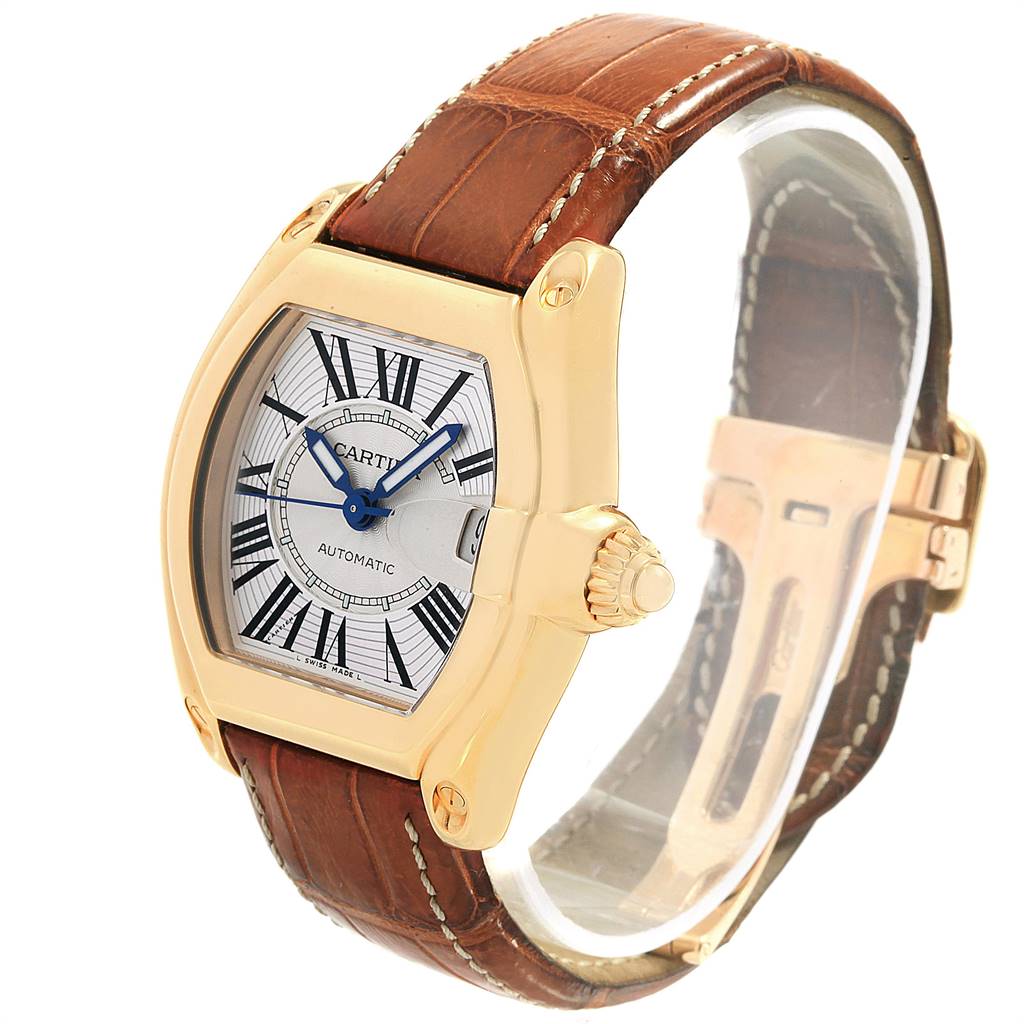 The image shows a Cartier Roadster W62005V2 Men's Yellow Gold Silver Dial W62005V2 Men's Yellow Gold Silver Dial watch angled to display the dial, crown, leather strap, and clasp.