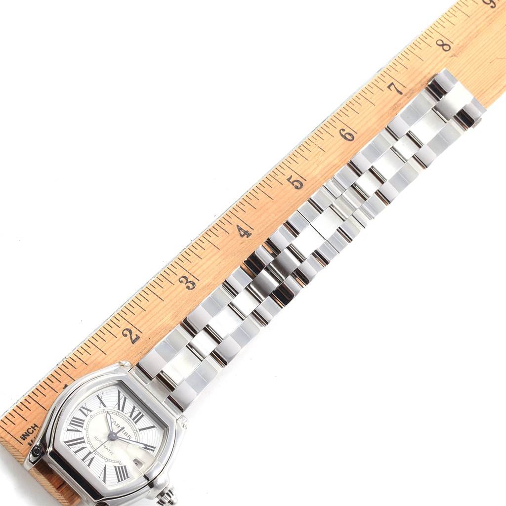 The Cartier Roadster W62025V3 Men
s Stainless Steel Silver Dial W62025V3 Men
s Stainless Steel Silver Dial watch is shown from a top-down angle, displaying the dial and bracelet alongside a ruler for scale.