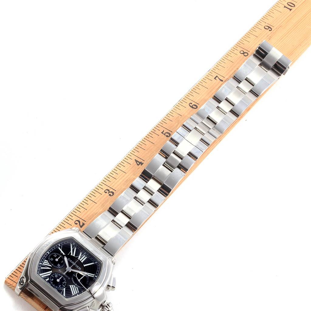 The image shows the Cartier Roadster W62020X6 Men's Stainless Steel Black Dial W62020X6 Men's Stainless Steel Black Dial watch from a top view, highlighting the face and the bracelet, measured against a ruler.