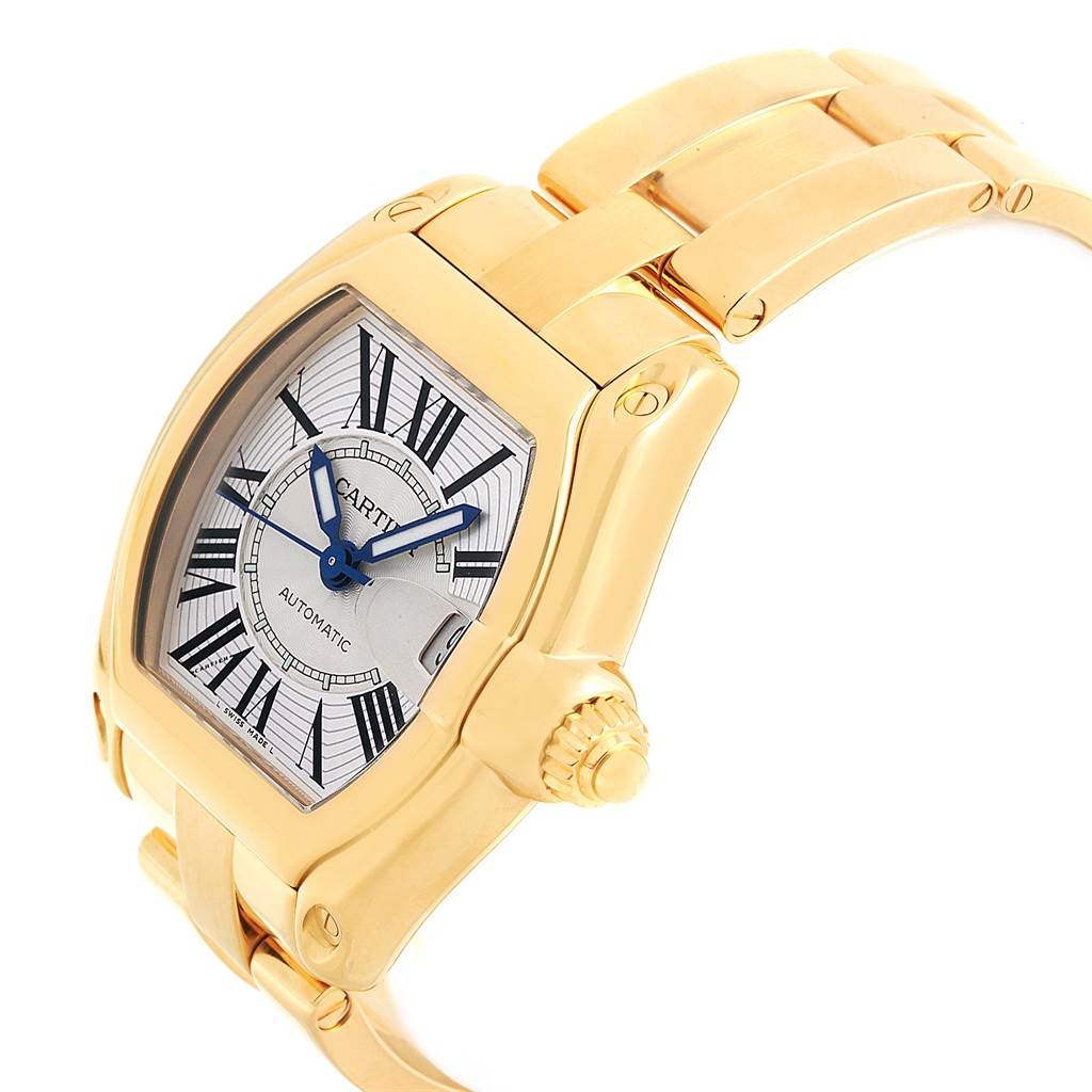The image shows a gold Cartier Roadster W62005V1 Men's Yellow Gold Silver Dial W62005V1 Men's Yellow Gold Silver Dial watch at an angle highlighting the dial, case, part of the bracelet, and the crown.