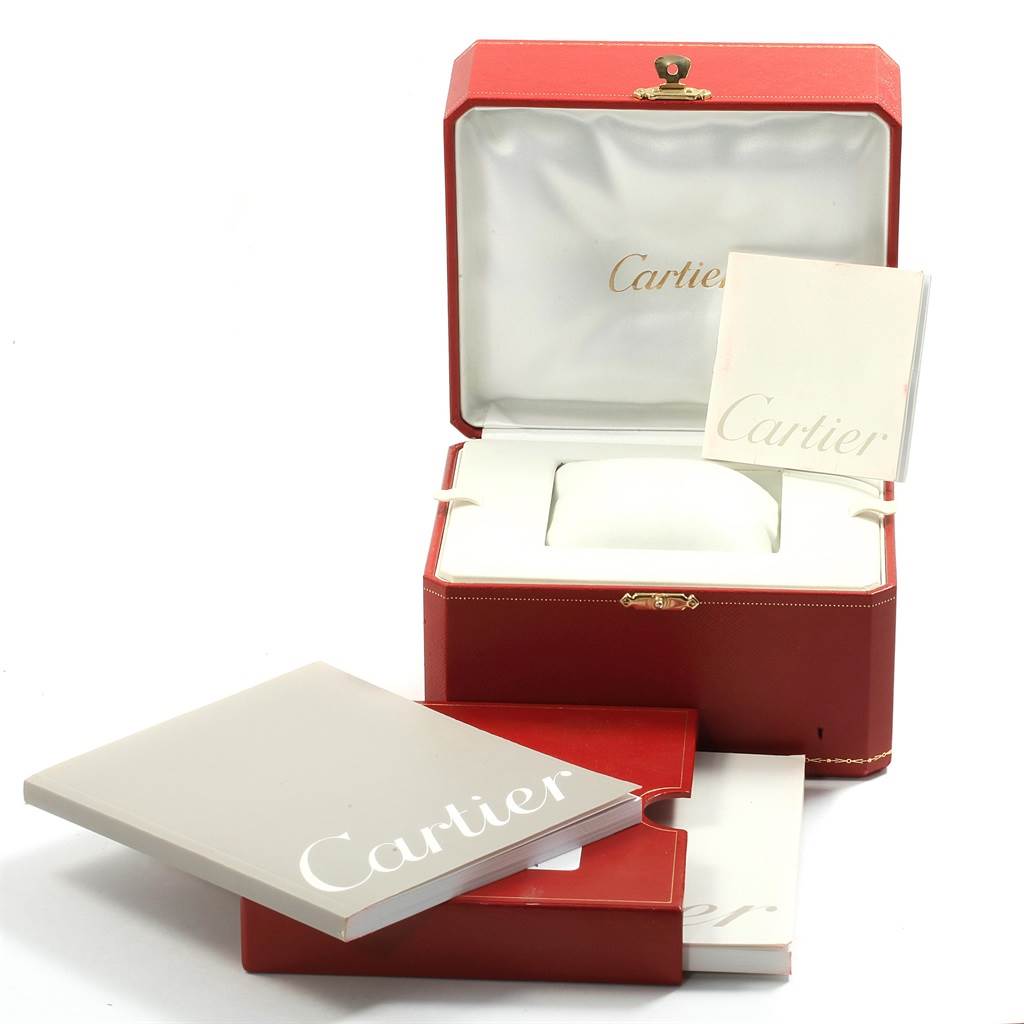 The image shows the open packaging for a Cartier Roadster W62005V1 Men's Yellow Gold Silver Dial W62005V1 Men's Yellow Gold Silver Dial watch, including the display box and accompanying booklets.