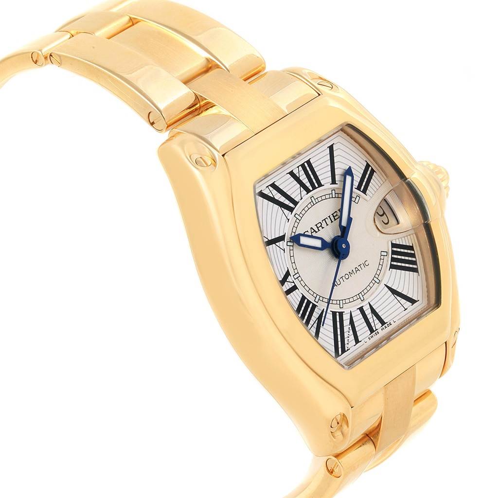 The image shows a Cartier Roadster W62005V1 Men's Yellow Gold Silver Dial W62005V1 Men's Yellow Gold Silver Dial watch at an angle, displaying the face, crown, and part of the bracelet.