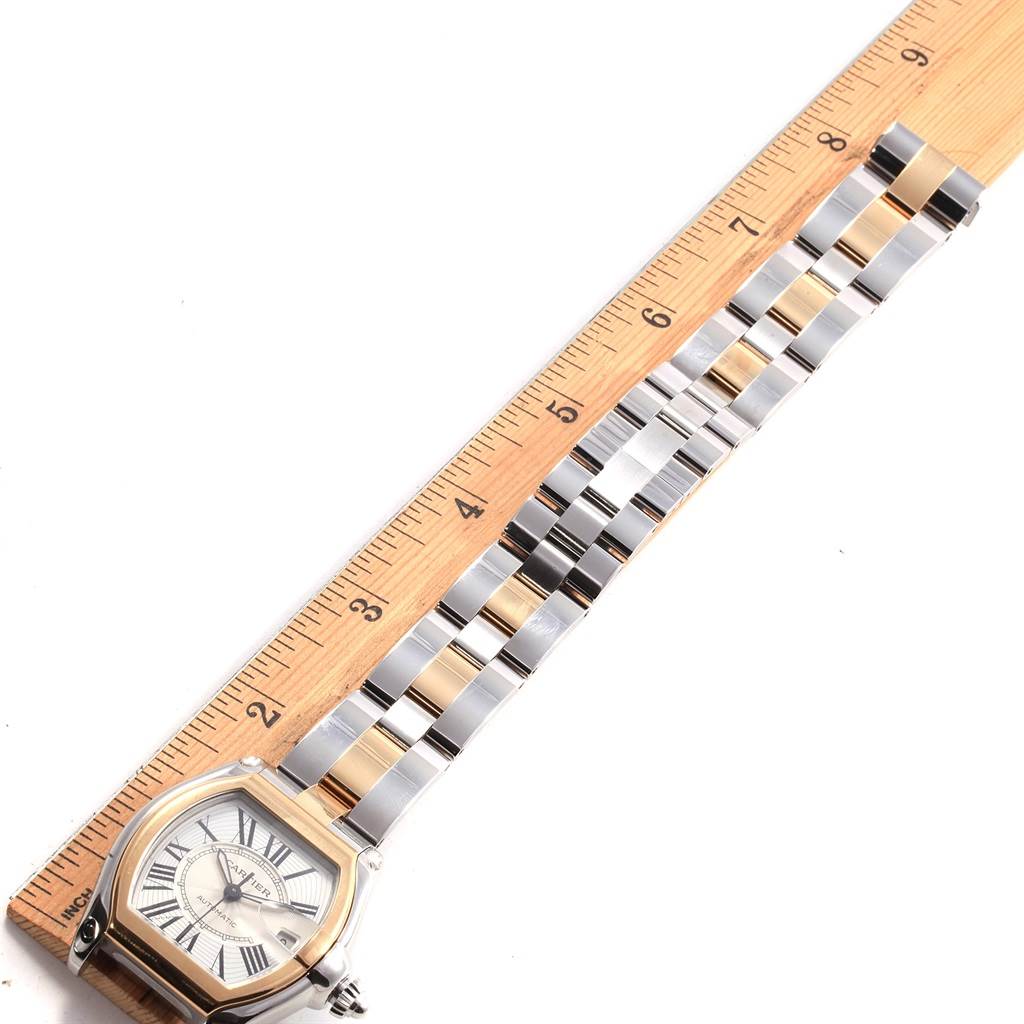 This image shows the Cartier Roadster W62031Y4 Men
s Steel and Gold (two tone) Silver Dial W62031Y4 Men
s Steel and Gold (two tone) Silver Dial watch laid flat with the face and bracelet visible alongside a ruler for size reference.