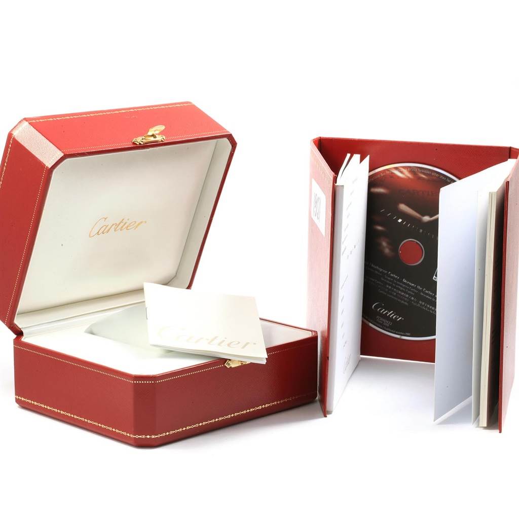 The image shows the Cartier Roadster W62002V3 Men
s Stainless Steel Black Dial W62002V3 Men
s Stainless Steel Black Dial watch packaging with an open red box, instructions, and a CD.
