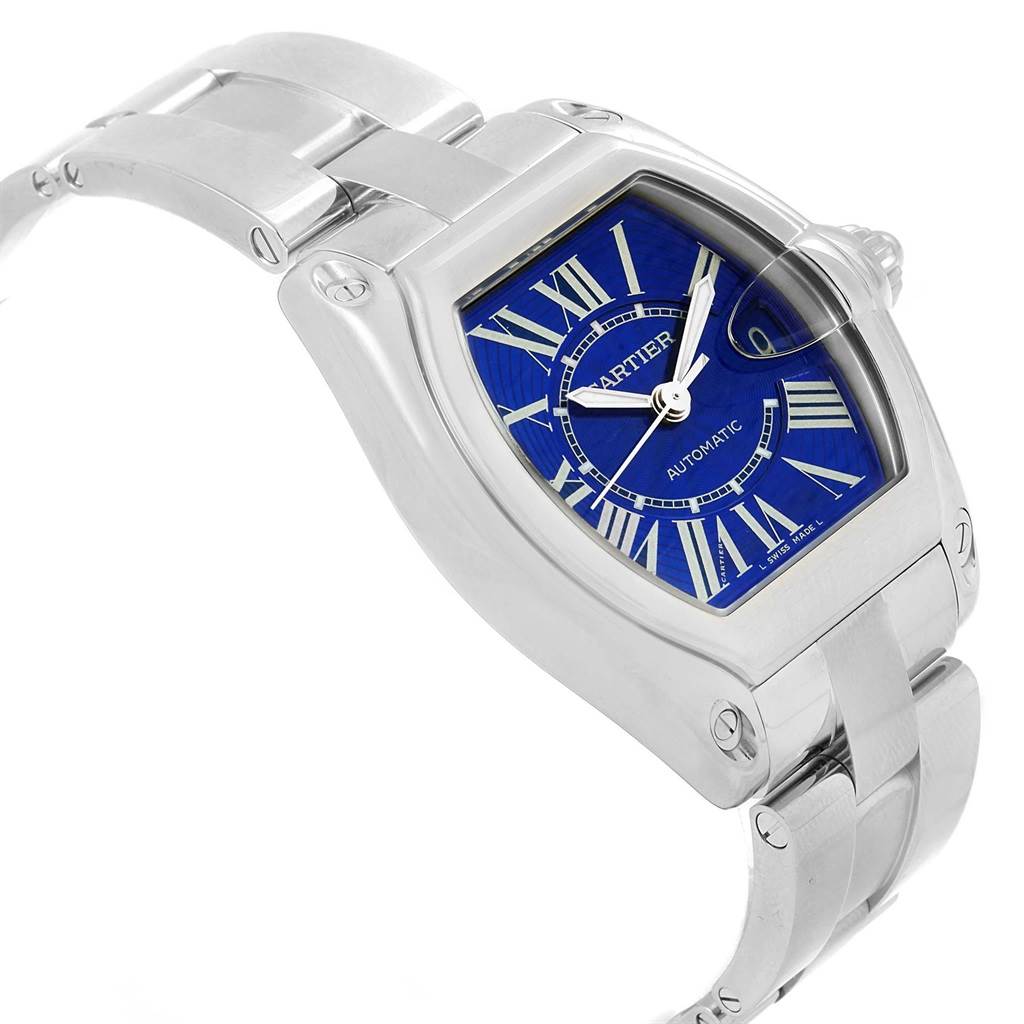 The image shows a Cartier Roadster W62048V3 Men's Stainless Steel Blue Dial W62048V3 Men's Stainless Steel Blue Dial watch at a three-quarter angle, highlighting its blue dial, Roman numerals, and stainless steel bracelet.