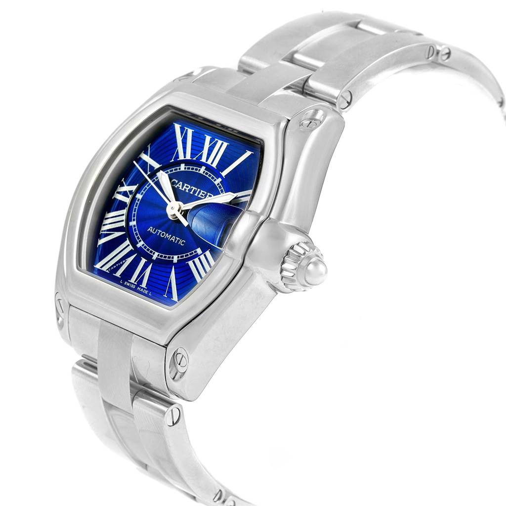 The image shows a Cartier Roadster W62048V3 Men's Stainless Steel Blue Dial W62048V3 Men's Stainless Steel Blue Dial watch at an angled side view, highlighting its blue dial, case, and part of the metal bracelet.